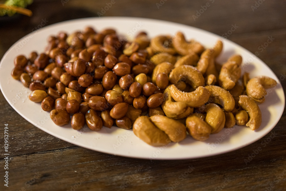 Fresh roasted salted peanuts and cashew on the table dinner party
