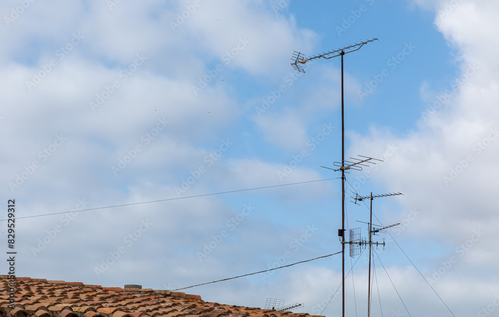 TV Antennas on Rooftop in Urban Cityscape TV Antennas on Rooftop in Urban Cityscape