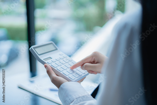 Woman doing calculations with a calculator photo
