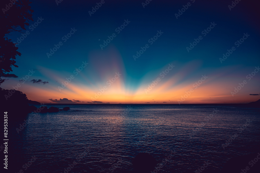 Sun going down in the water in the Seychelles island of Praslin, releasing amazing color waves. Sun going down in the water in the Seychelles island of Praslin, releasing amazing color waves.
