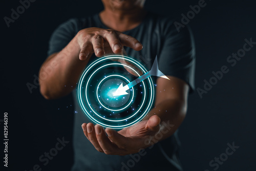 hand of businessman holding target icon of success, leaders project and business success, achieving goals objective target strategy planning and concept.