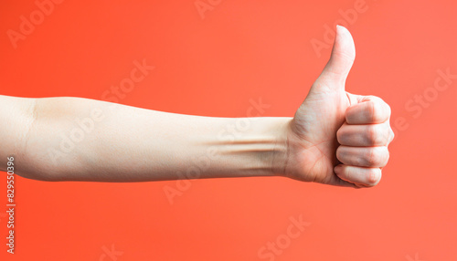 A person s arm is stretched and giving a thumbs up photo