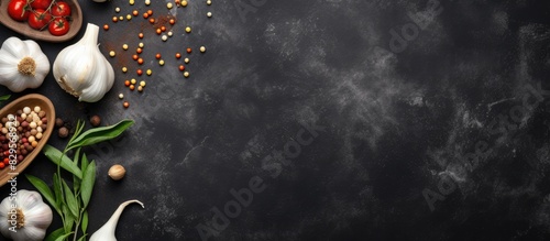 Fresh garlic arrows marinating on a dark gray concrete background with ingredients such as salt sugar vinegar bay leaf water and sweet pepper against a copy space image photo