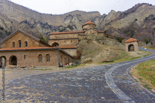 Refectory and church of monastery complex. A rock with cells is visible. Shio-mgvime monastery. photo