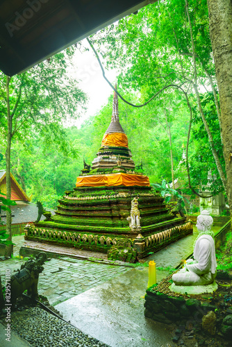 Ancient pagoda covered with moss in the rainy season at Wat Pha Lat