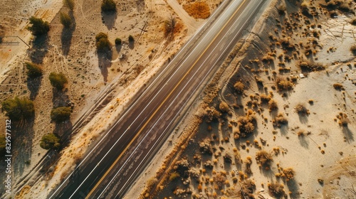 Breathtaking aerial view of desert road trip landscape. Dramatic aerial perspective showcasing vast desert scenery.