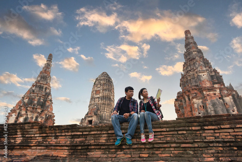 Tourists with map in hand looking at a temple in Ayutthaya, Thailand at Wat Mahathat photo