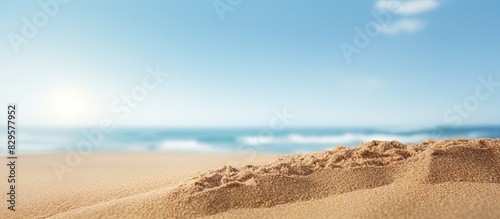 Sand in a close up shot with a blurry background of the sea and sky on a sunny summer day suitable for product placement with copy space image
