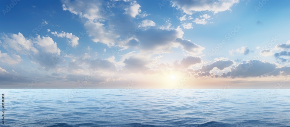 Fototapeta premium The morning sky boasts a vibrant blue hue with white clouds while the deep indigo ocean creates a calming and cool atmosphere ideal as a cold background with copy space above it