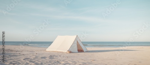 A white tent sits on a sandy beach its surrounding area empty offering a serene and inviting setting with lots of copy space image