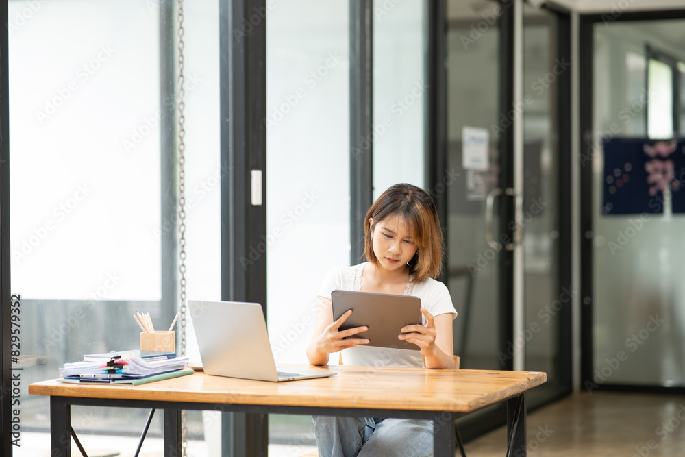 Asian business woman working with tablet Asian business woman working with tablet