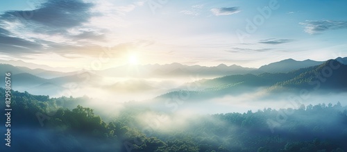 Aerial drone captures the sun s rays piercing through fog over the mountain forest creating a dramatic scene for a copy space image photo