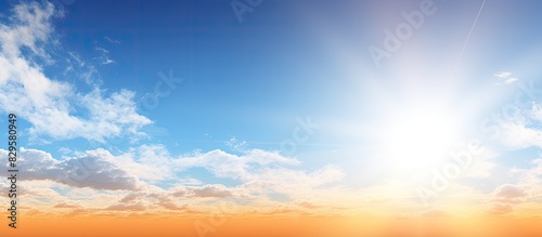 A serene scene of a sunny sky with a high sun position and some sparse clouds ideal for a copy space image