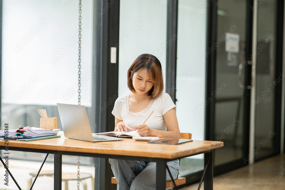 Asian businesswoman working on documents at office Asian businesswoman working on documents at office
