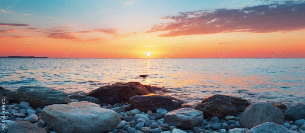Fototapeta premium Scenic view of stones with sunset and ocean in the background perfect for a copy space image