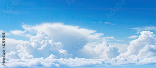 A serene cloud in shades of blue and white drifts gracefully across a clear sky ideal for a copy space image