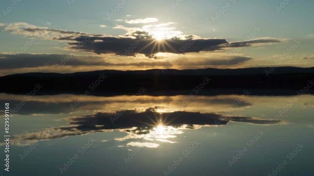 Sunset on the lake with a mirror image of the sky on the water. Landscape view of the lake, calm environment. Beauty is in nature. Sunset on the lake with a mirror image of the sky on the water. Landscape view of the lake, calm environment. Beauty is in nature.