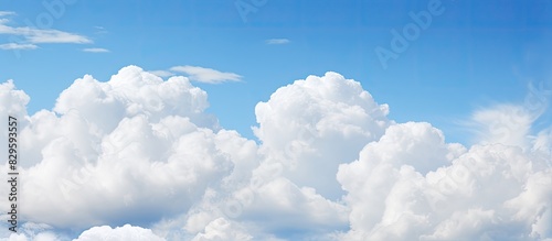 Fluffy white clouds against a blue sky providing a serene backdrop for the copy space image