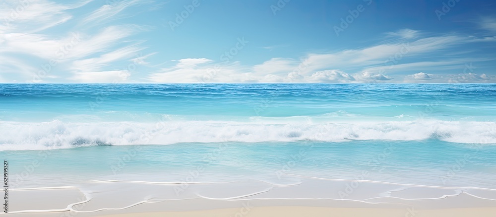 A beach setting with a sunny sky and clear ocean waters perfect for a copy space image