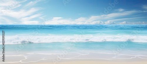 A beach setting with a sunny sky and clear ocean waters perfect for a copy space image