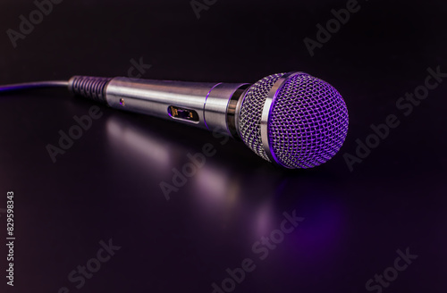 microphone on a black background with purple backlight