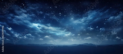 A serene summer night with a dark blue sky filled with twinkling stars light white clouds moving swiftly creating a peaceful atmosphere. Copy space image. Place for adding text and design © Ilgun