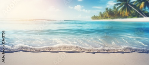 A blurred tropical beach backdrop with sunlit bokeh waves Ideal for summer vacation and travel themes with a vintage color tone filter and copy space image