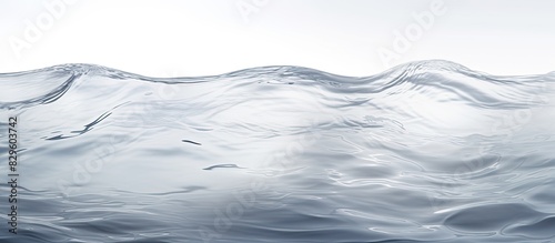 Gray abstract background with waves on a clear water surface providing copy space image © Ilgun