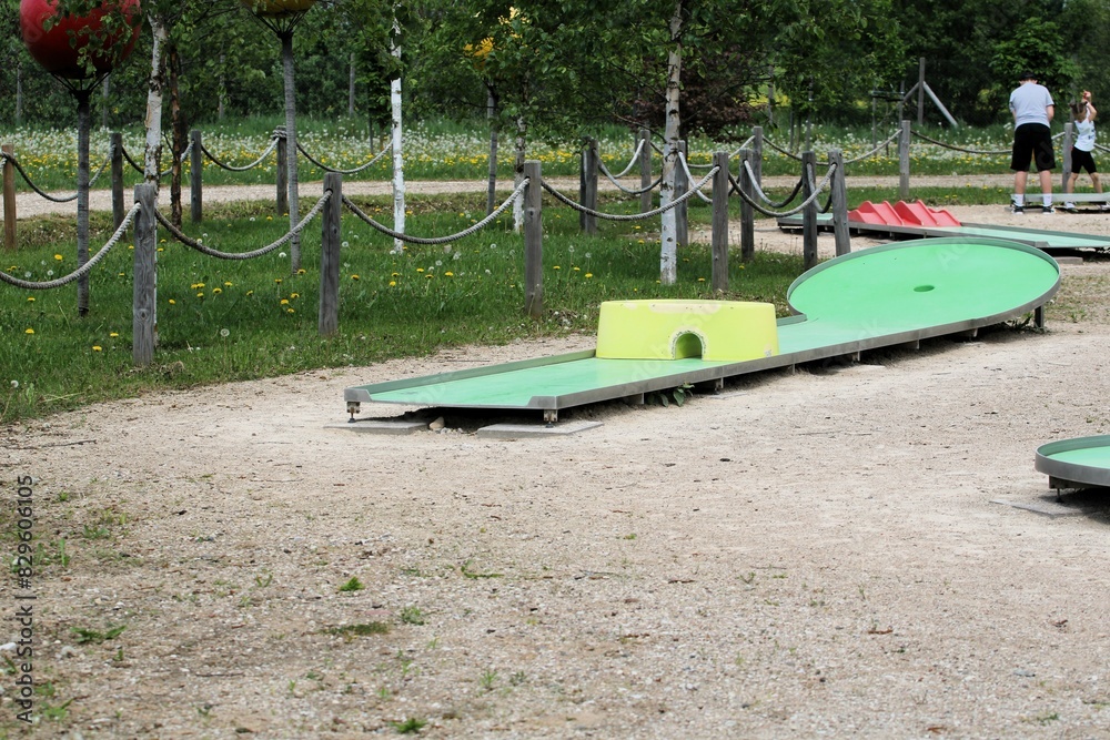 mini golf park with wooden fence ropes and green birch trees in summer mini golf park with wooden fence ropes and green birch trees in summer
