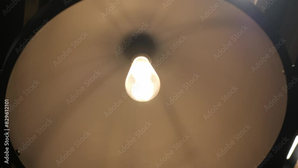 view of lamp light ceiling decoration in cafe with lonely ordinary minimal electric light bulb hanging and swinging in the dark room view of lamp light ceiling decoration in cafe with lonely ordinary minimal electric light bulb hanging and swinging in the dark room