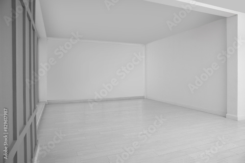 Empty room with white walls and laminated floor