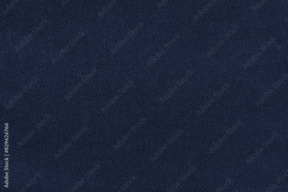Dark blue cotton drill fabric pattern close up as background Dark blue cotton drill fabric pattern close up as background