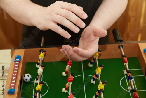 Hands applauding over the foosball table, Applause for the winner in the game, Playing foosball, Close-up