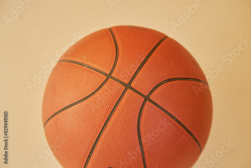 Basketball on yellow background closeup, sporty backdrop