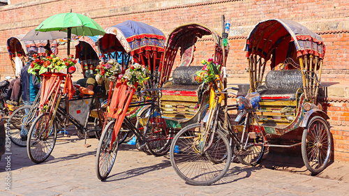 NEPAL, KATHMANDU, December 2023, People at Cycle Rikshaw Parking in Line, Kathmandu Durbar Square photo