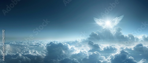 Angel wings form in clouds with a bright light shining through. photo