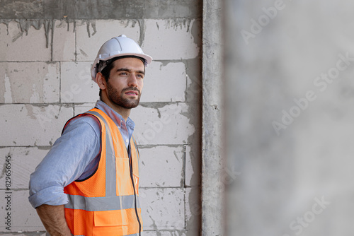 Young architect man wearing builder safety helmet over isolated background happy face smiling with crossed arms looking at the camera. Positive person.