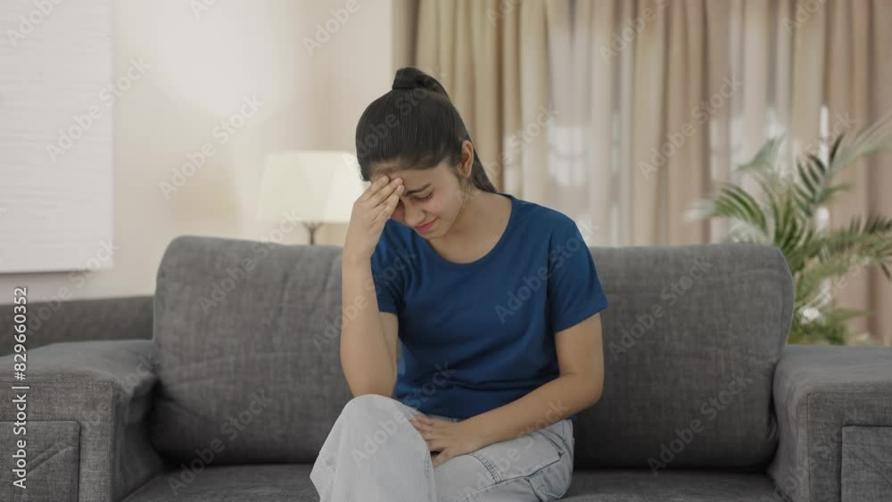 Sick Indian teenage girl having a headache Sick Indian teenage girl having a headache