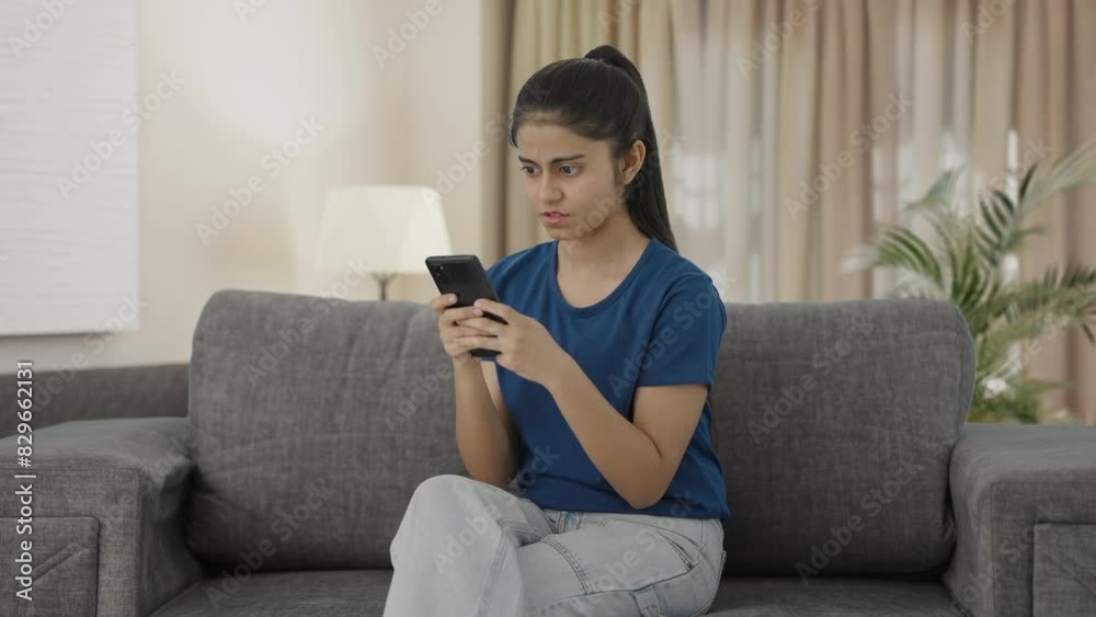 Angry Indian teenage girl chatting with someone