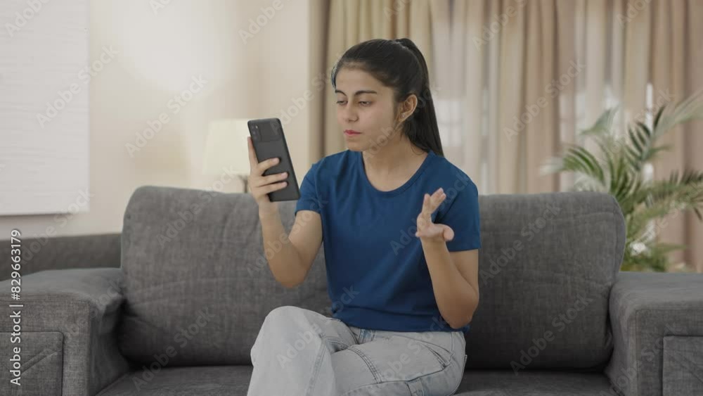 Angry Indian teenage girl shouting on video call Angry Indian teenage girl shouting on video call
