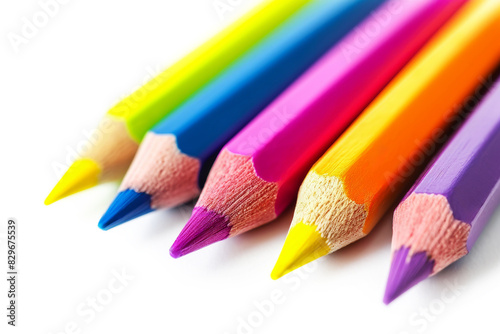 Close-up of colorful pencils arranged in a row, showcasing their vibrant hues on the white background with copy space. Concept for back to school and creativity-themed content.