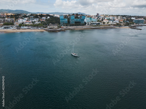 Coastal cityscape with sailboat in Cascais Portugal, photographed by drone on a spring day. photo