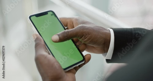 First-person view, dark-skinned man uses a smartphone with a green screen, chroma key template, a businessman works on the go.