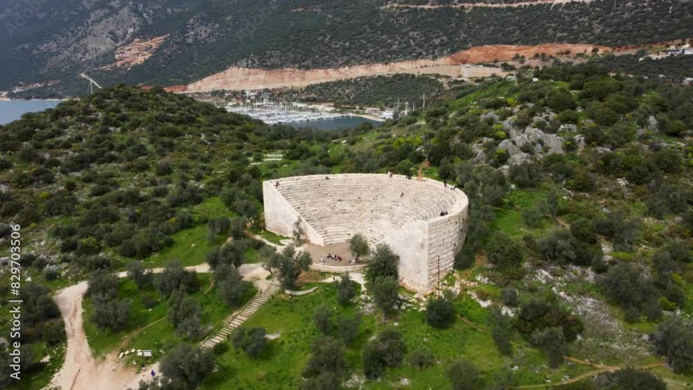 Fly Up Above 1st Century BCE Ancient Amphitheater Overlooking the Mediterranean Sea Towards Greek Islands, Antiphellos Theatre with Coastal View, in Kas, Turkey: Turkish South Coast. Kaş Türkiye Fly Up Above 1st Century BCE Ancient Amphitheater Overlooking the Mediterranean Sea Towards Greek Islands, Antiphellos Theatre with Coastal View, in Kas, Turkey: Turkish South Coast. Kaş Türkiye