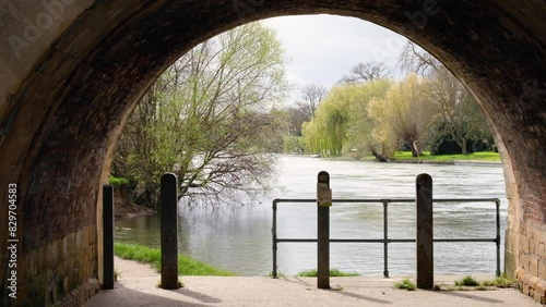 Scenic view of River Thames under stone arch of bridge in the historic market town and civil parish of Wallingford, South Oxfordshire, England photo