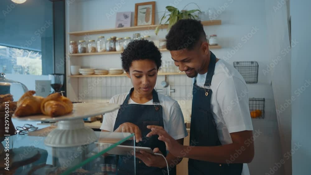 Cinematic image of employees working in a nordic styled cafe.