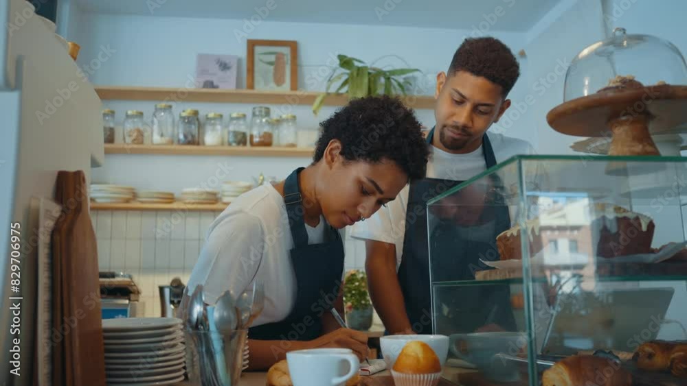Cinematic image of employees working in a nordic styled cafe. Cinematic image of employees working in a nordic styled cafe.