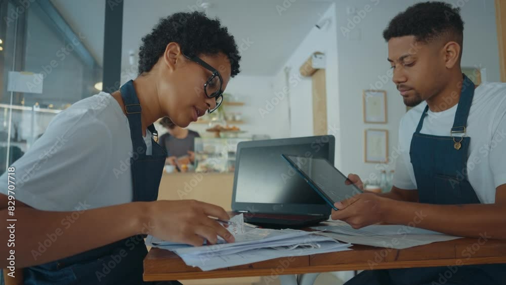 Cinematic image of employees taking care of the general accounting of the small business cafe. Cinematic image of employees taking care of the general accounting of the small business cafe.