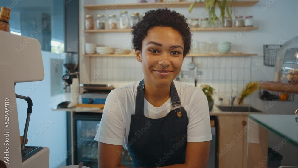 Beautiful woman working in a nordic styled cafe smiling in camera. Beautiful woman working in a nordic styled cafe smiling in camera.