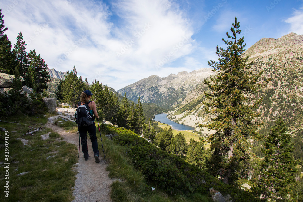 Young hiker woman in Vall de Boi, Aiguestortes and Sant Maurici National Park, Spain Young hiker woman in Vall de Boi, Aiguestortes and Sant Maurici National Park, Spain